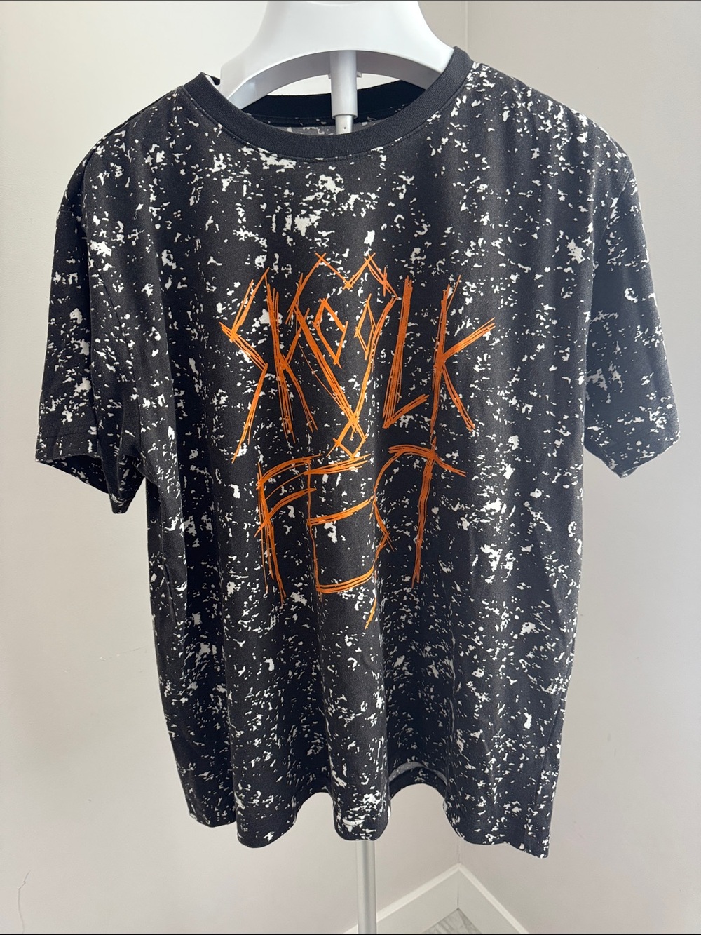Original Use Black Tee with White Splatter and Orange Accent